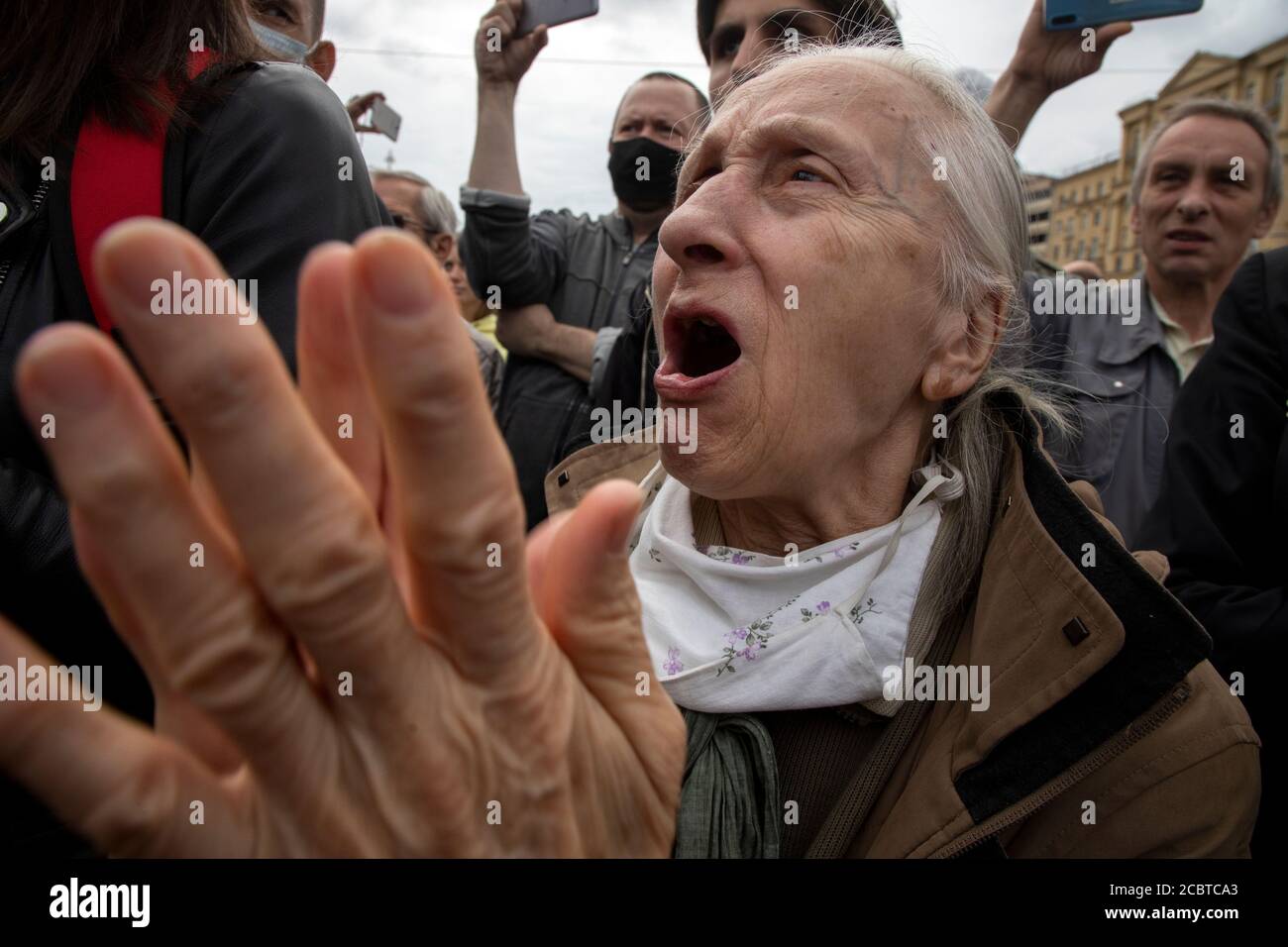 Moscow, Russia. 15th of August, 2020 Old woman takes part in a political rally in support of protesters in Khabarovsk Russian region and Belarus, at Pushkin square in central Moscow, Russia. Blogger Valery Solovei called Russian citizens walk on central street of Russian cities and feed the pigeons with the Civil Solidarity with Belarus and Khabarovsk political protests, in all cities of Russia on Saturday. 15th of August Stock Photo