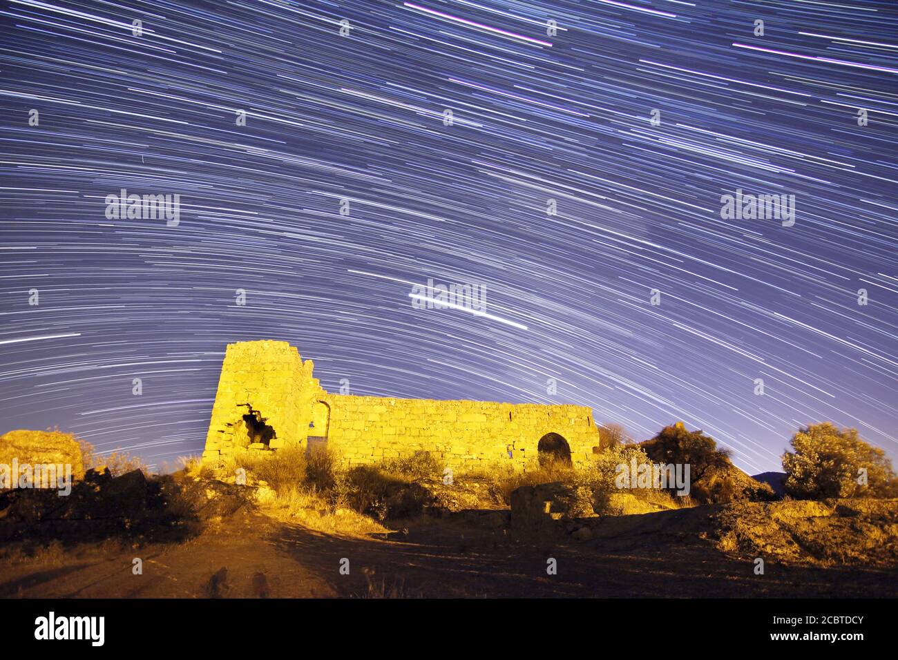 night view of the castle. A view of the stars of the Milky Way with a mountain top in the foreground. Night sky nature summer landscape. Perseid Meteo Stock Photo