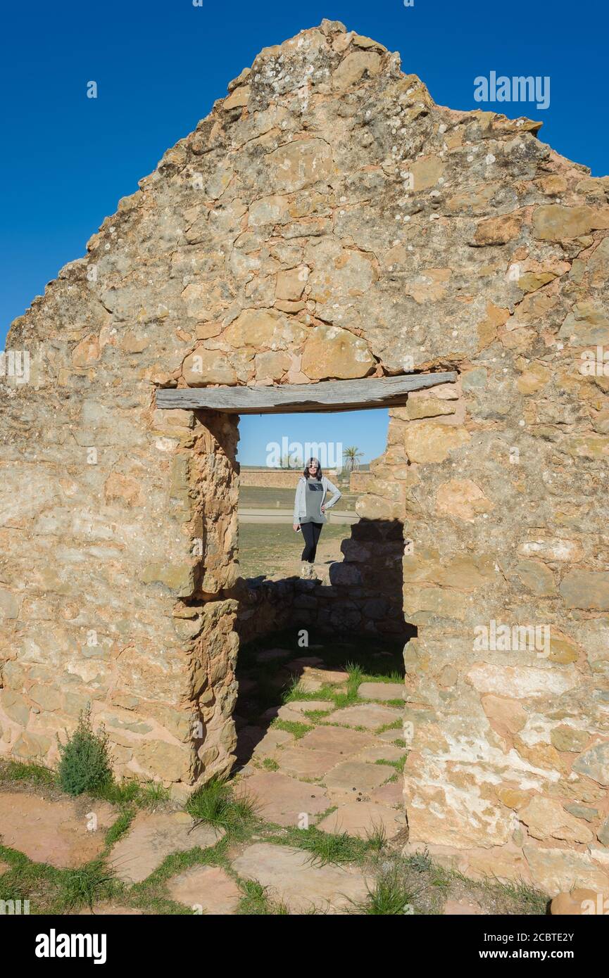Female model standing in the doorway of old ruins at Kanyaka historical homestead in the Flinders Ranges of South Australia. Stock Photo