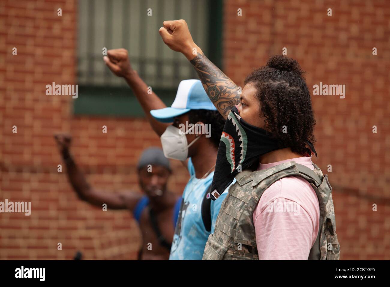 Washington, DC, USA. 15th Aug, 2020. Pictured: two of the leaders of the Defund the Police March walk with raised fists through Georgetown. Credit: Allison C Bailey/Alamy Credit: Allison Bailey/Alamy Live News Stock Photo