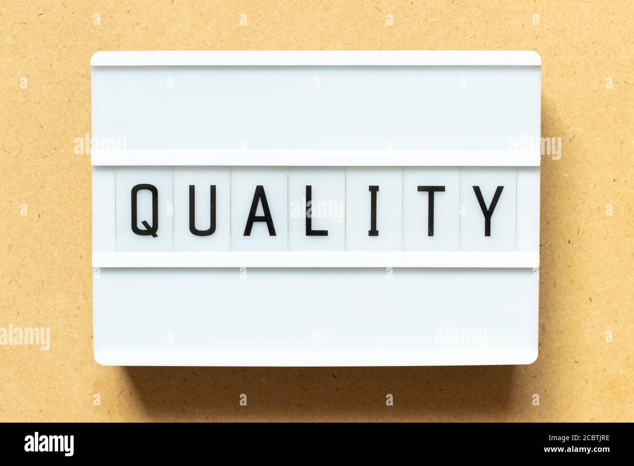 Lightbox with word quality on wood background Stock Photo