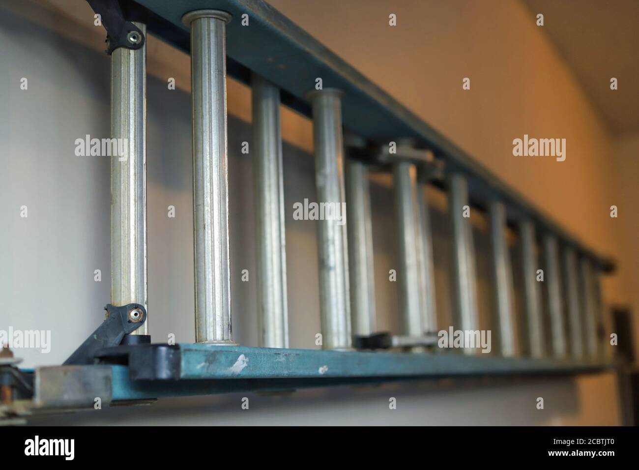 A close up image of a ladder on a hook in a garage Stock Photo - Alamy