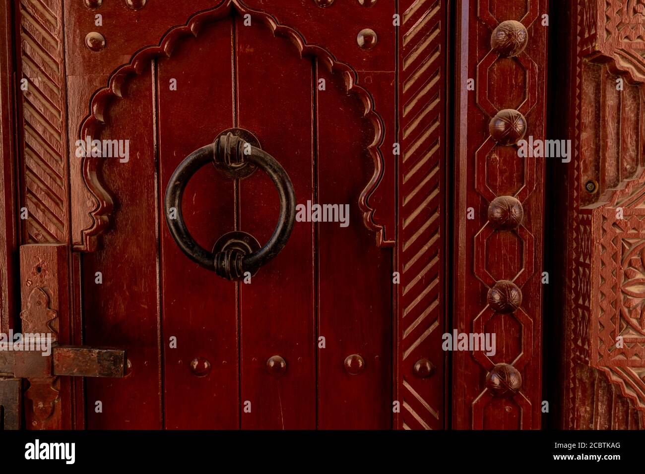 An omani style door with a huge knob Stock Photo