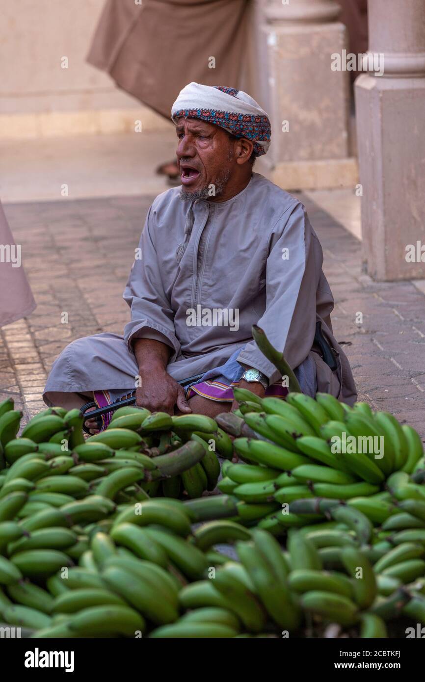 An Arab man selling raw bananas at the Friday souq Stock Photo