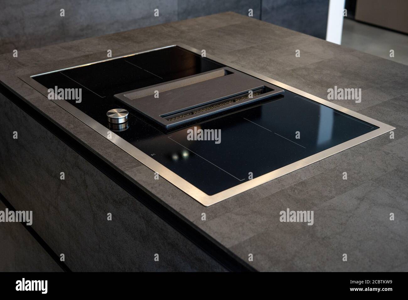 Modern luxury kitchen. Modern black induction cooker on marble