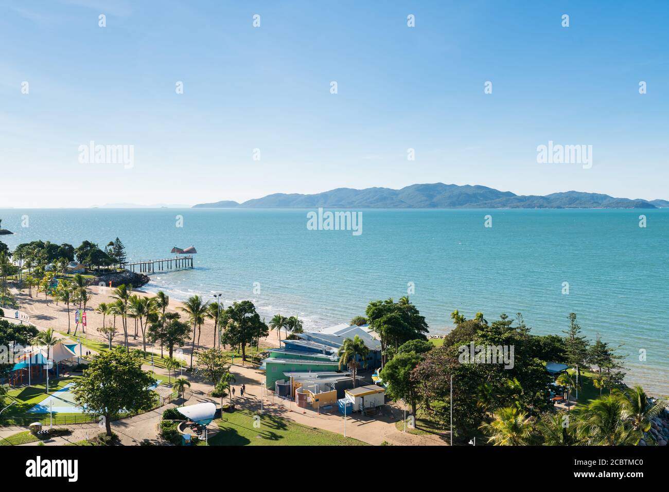 View of Magnetic Island and the jetty on The Strand beach, Townsville, Australia from high view point Stock Photo