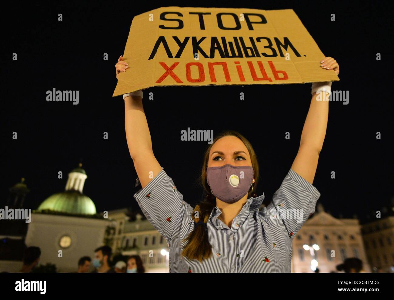 Krakow, Poland. 15th Aug, 2020. A protester holds a placard that says Stop Lukashism Enough during the demonstration. Hundreds of Belarusian people living in Krakow and local supporters gathered during the Solidarity Rally organized at Krakow's Market Square outside Adam Mickiewicz monument against the Belarusian leader, Alexander Lukashenko. Credit: SOPA Images Limited/Alamy Live News Stock Photo