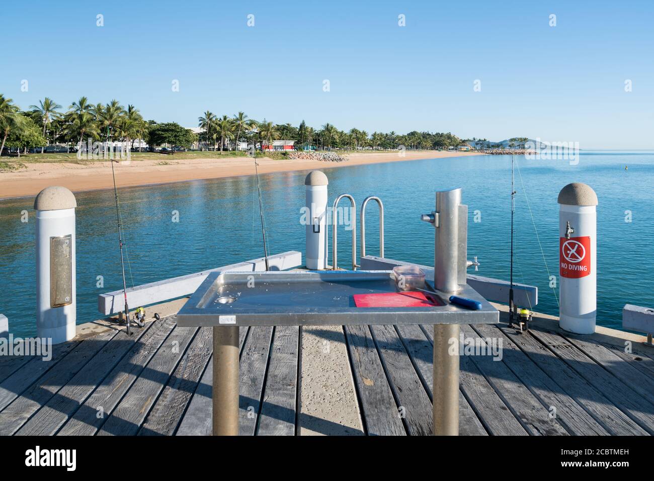 Popular fishing spot with fish cleaning station on the jetty at The Strand, Townsville, Australia Stock Photo