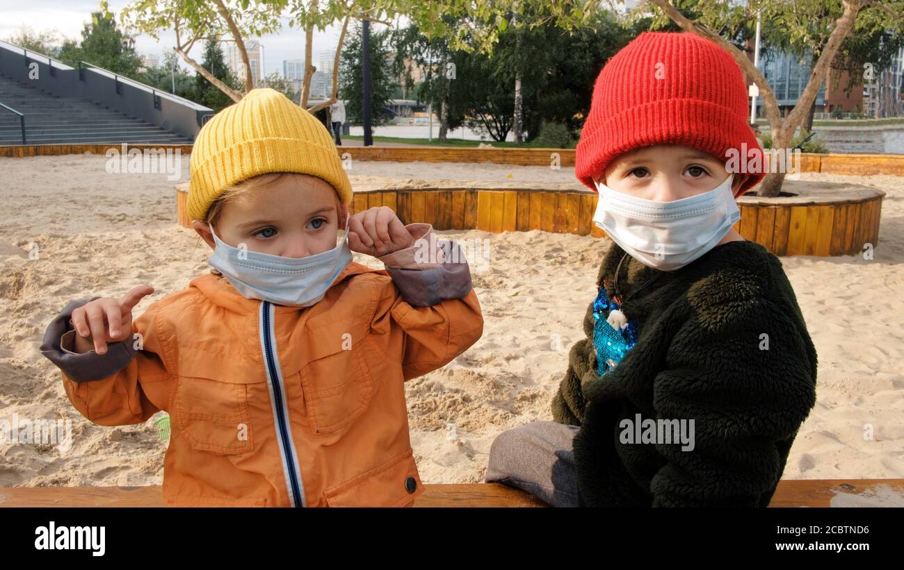 Children in protective masks are walking Stock Photo