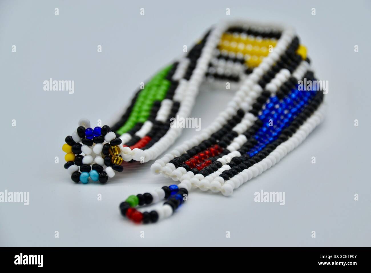 Handmade colourful beaded South African bracelet in studio shot on a white background Stock Photo