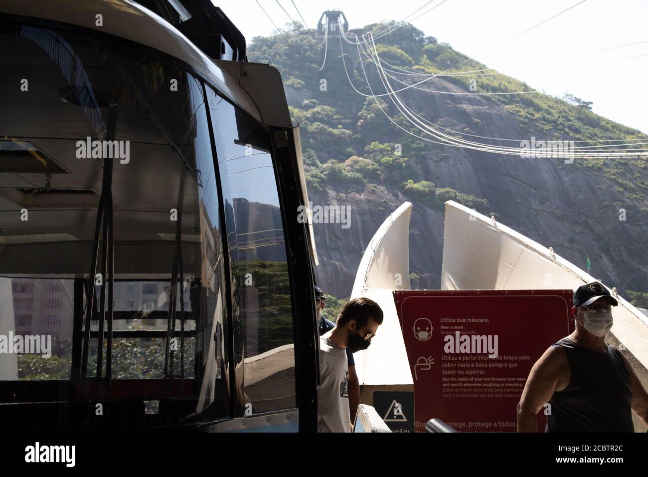 Rio De Janeiro, Brazil. 15th Aug, 2020. People with mouthguards leave the Bondinho, the cable car at Sugar Loaf Mountain, which has reopened after months of closure. Brazil is currently the second most affected country worldwide by the corona virus. Credit: Ian Cheibub/dpa/Alamy Live News Stock Photo