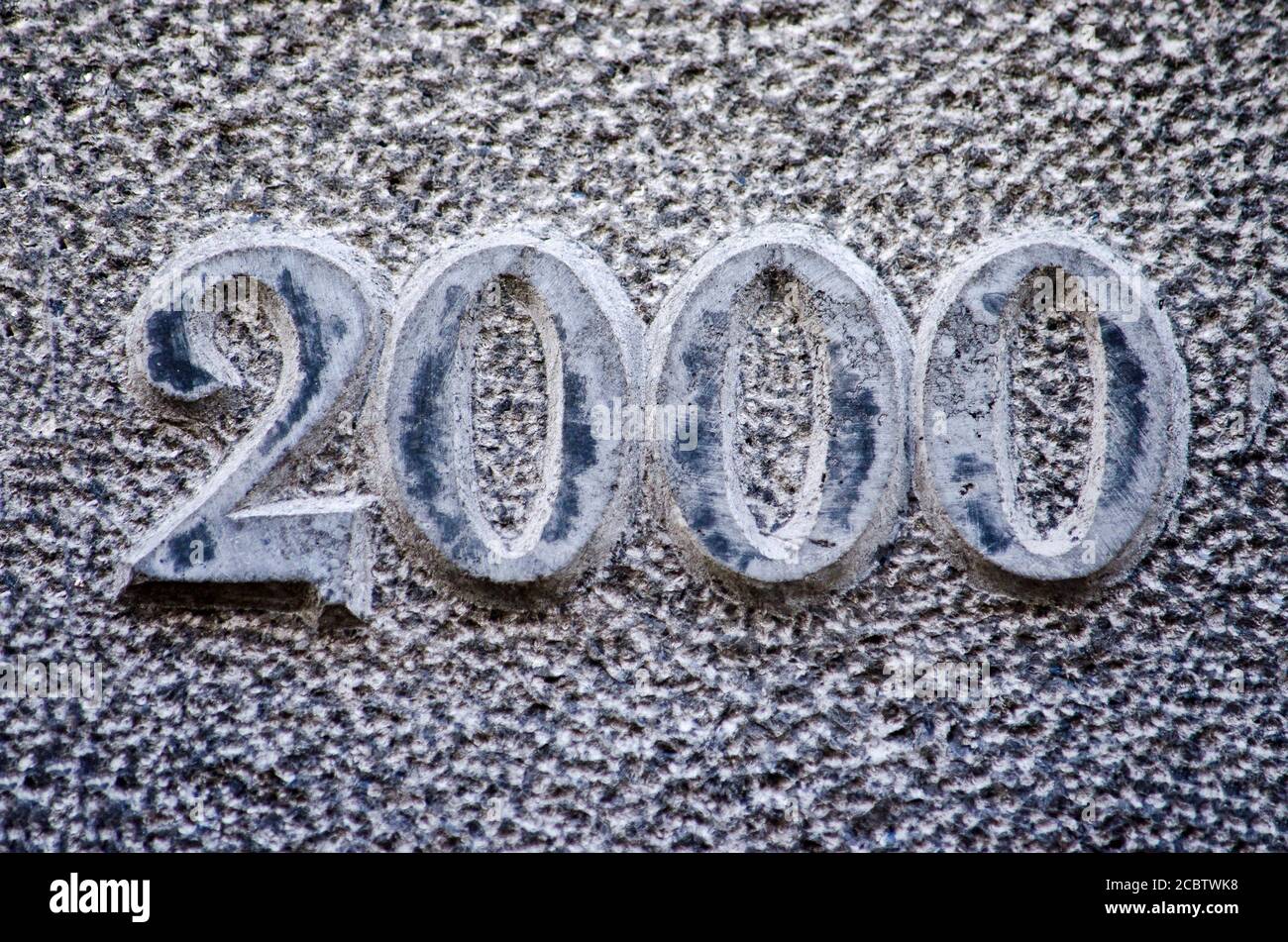 Date-stone in a rough blueish stone material with the year 2000 embossed Stock Photo