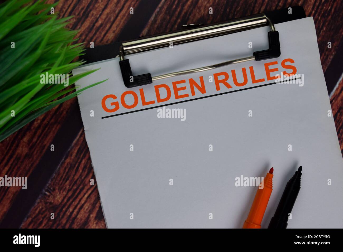 Golden Rules text write on a paperwork isolated on office desk. Stock Photo