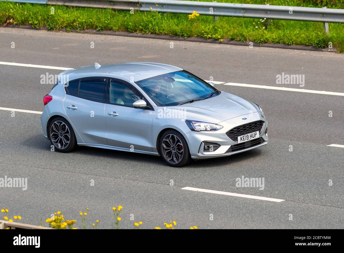 2019 silver Ford Focus St-Line X; Vehicular traffic moving vehicles, cars driving vehicle on UK roads, motors, motoring on the M6 motorway highway network. Stock Photo