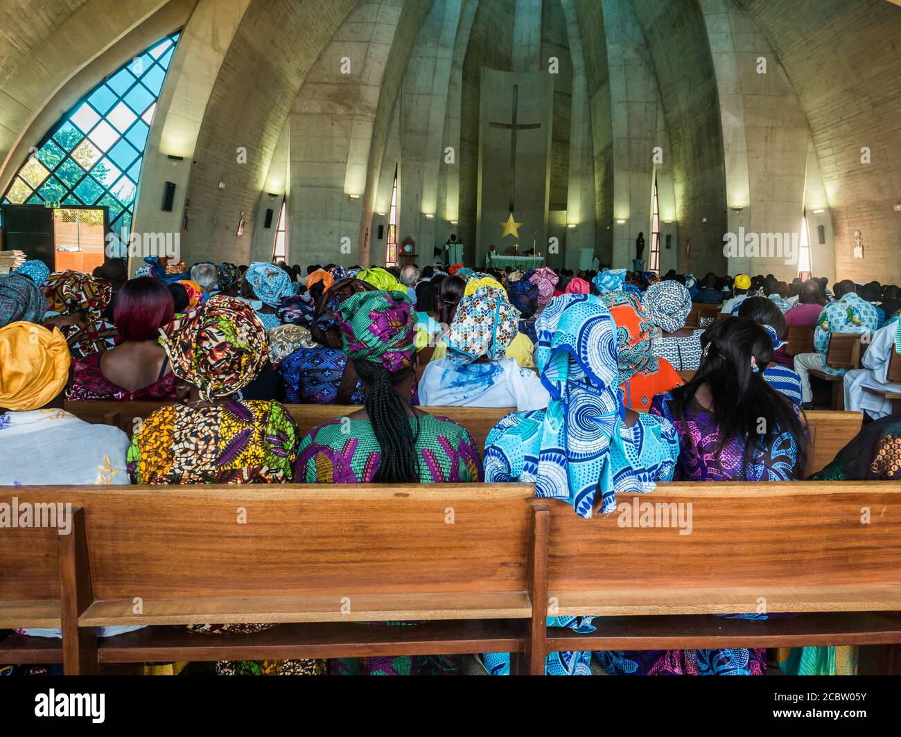 Senegal, Africa - January 2019: African people in colorful clothes (boubou) during a mass at a Catholic church in West Africa Stock Photo