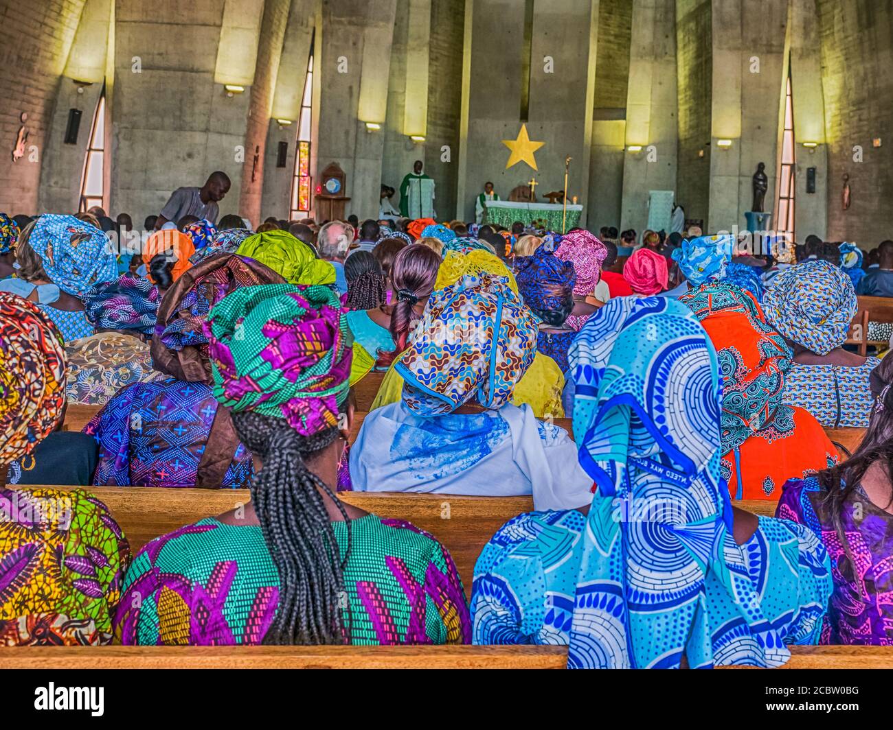 Senegal, Africa - January 2019: African people in colorful clothes (boubou) during a mass at a Catholic church in West Africa Stock Photo