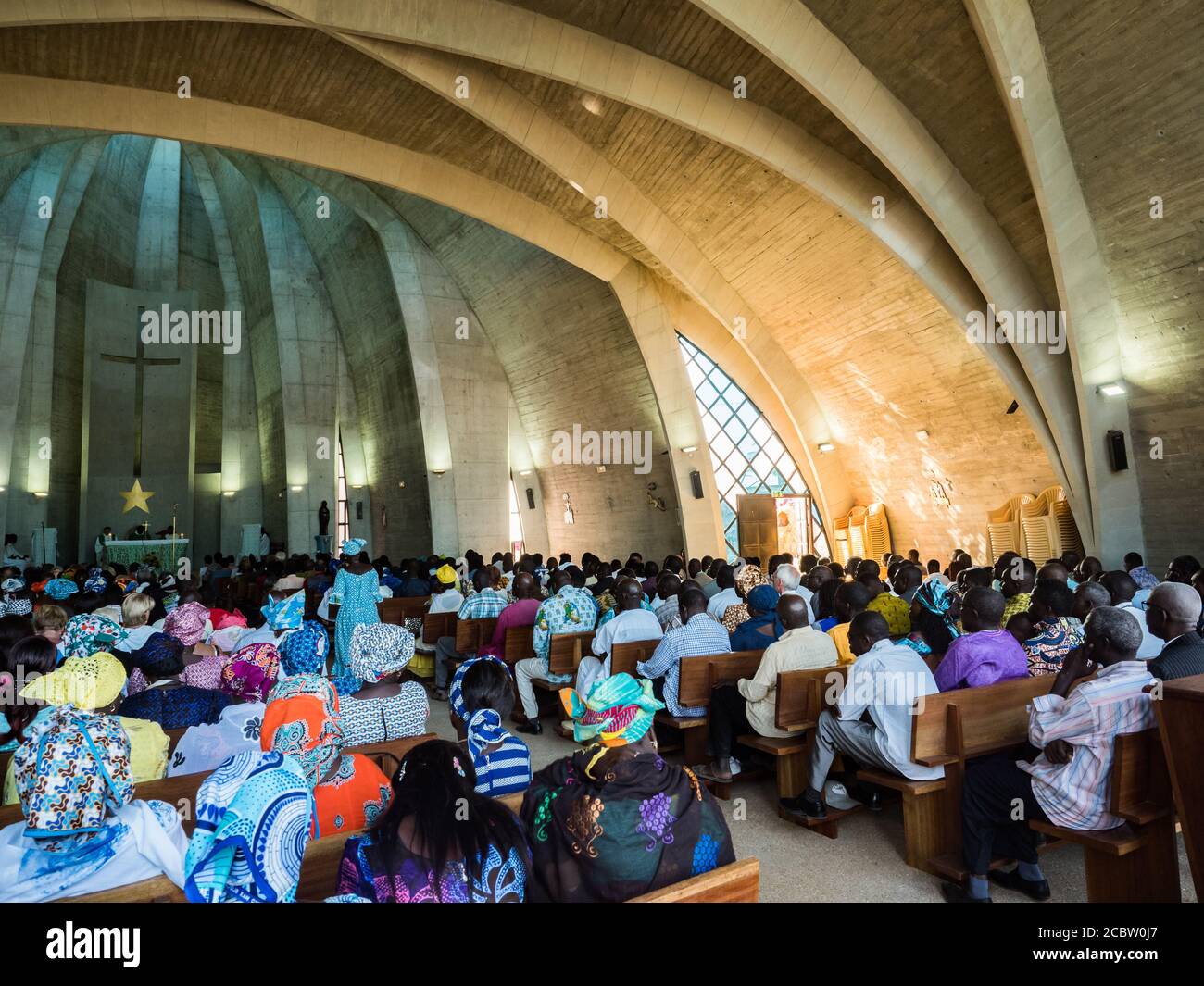 Senegal, Africa - January 2019: African people in colorful clothes (boubou) during a mass at a Catholic church in West Africa Stock Photo
