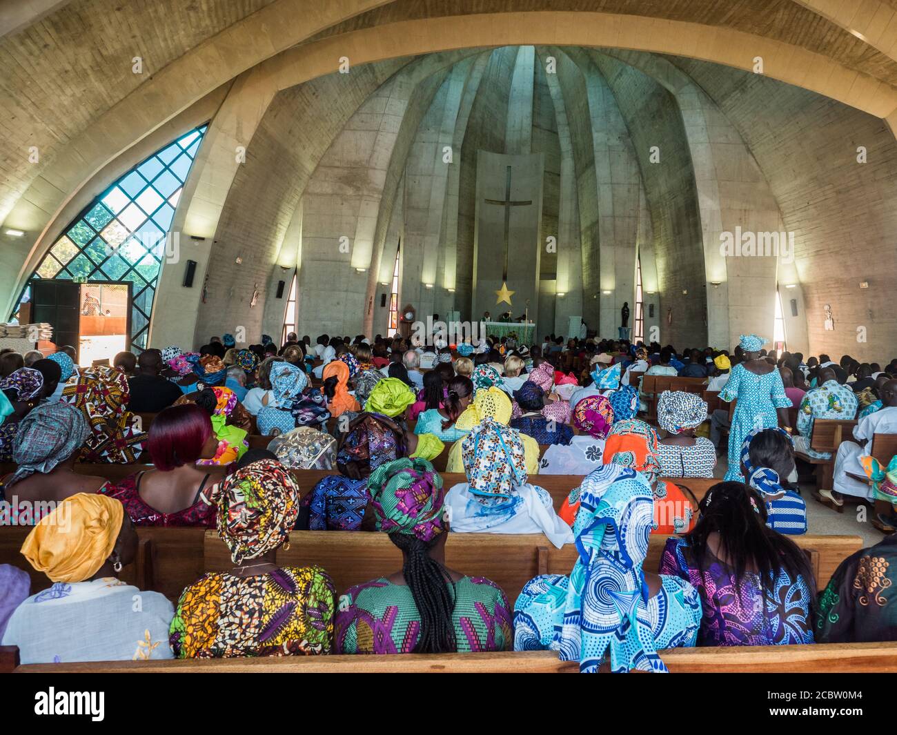 Senegal, Africa - January 2019: African people in colorful clothes (boubou) during a mass at a Catholic church in West Africa Stock Photo