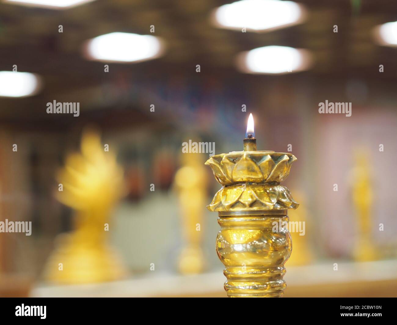 candles lit on the Brass candle holder at temple, candlelight Stock Photo Alamy