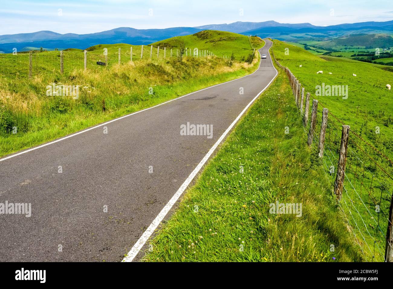 Single car on Rural road in mid Wales near Machynlleth Stock Photo