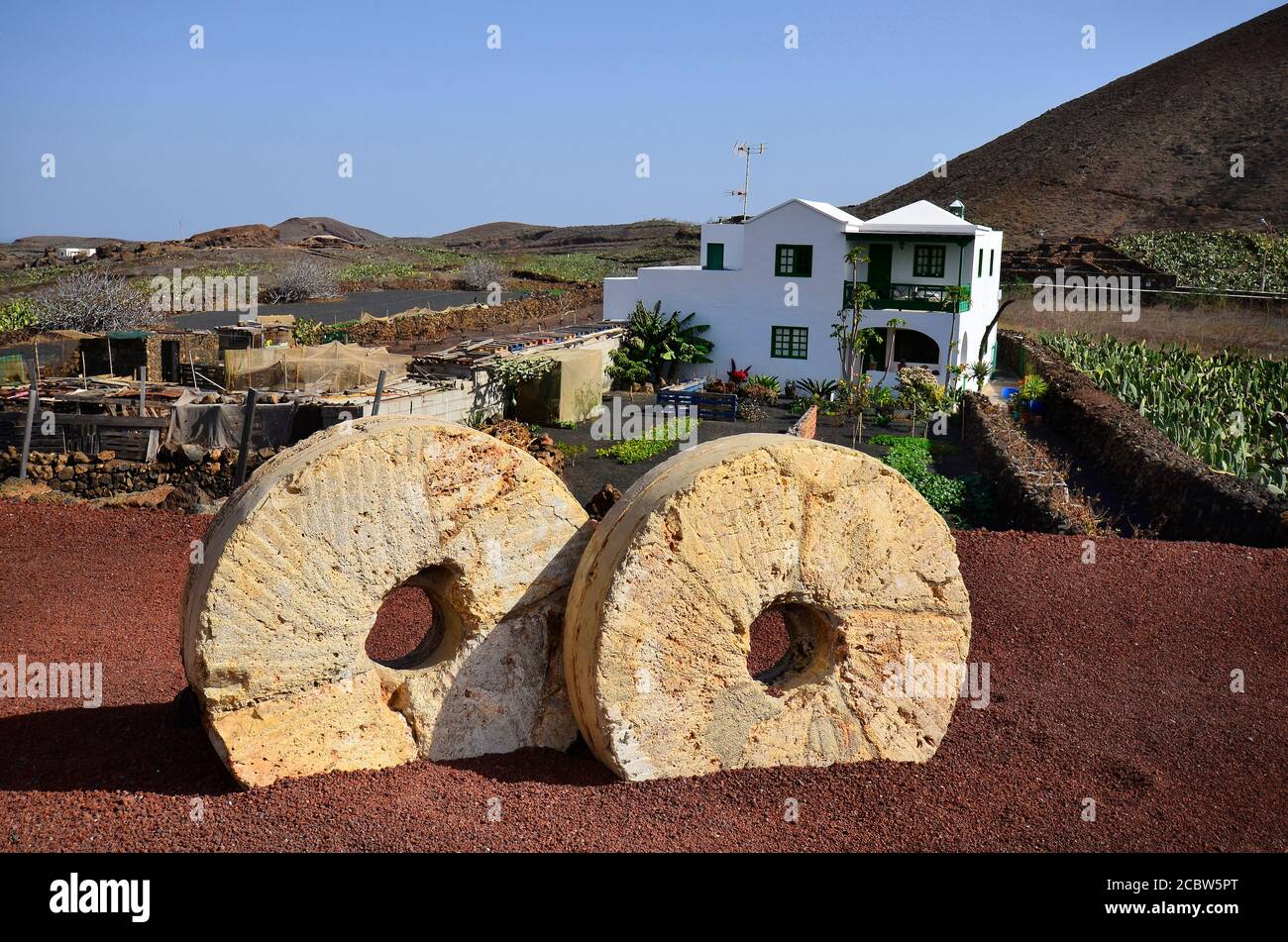 Spain, rural landscape with millstones and home designed in traditionall white and green colors on Lanzarote Stock Photo