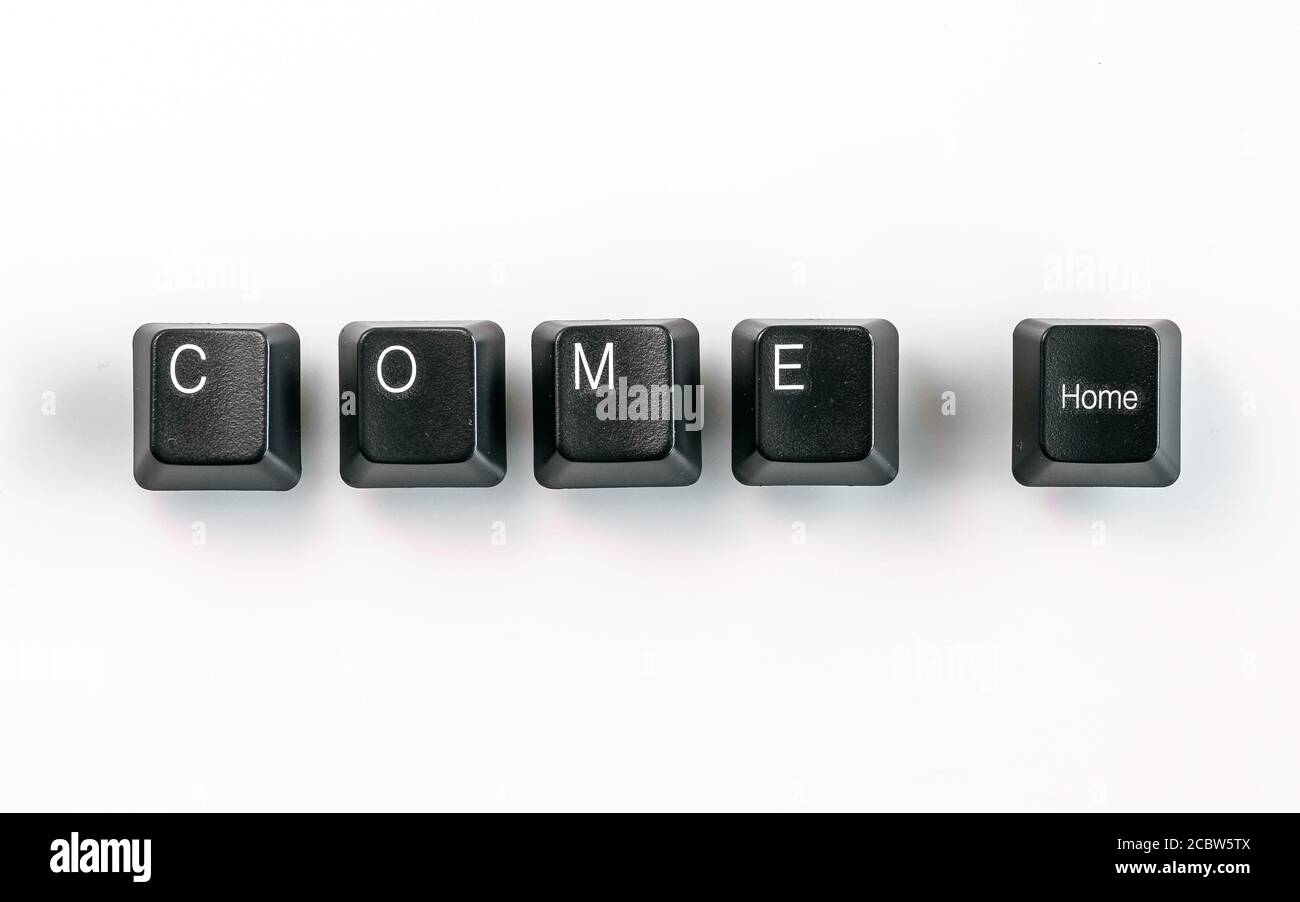 Computer keyboard keys spelling Come Home, isolated on white background Stock Photo