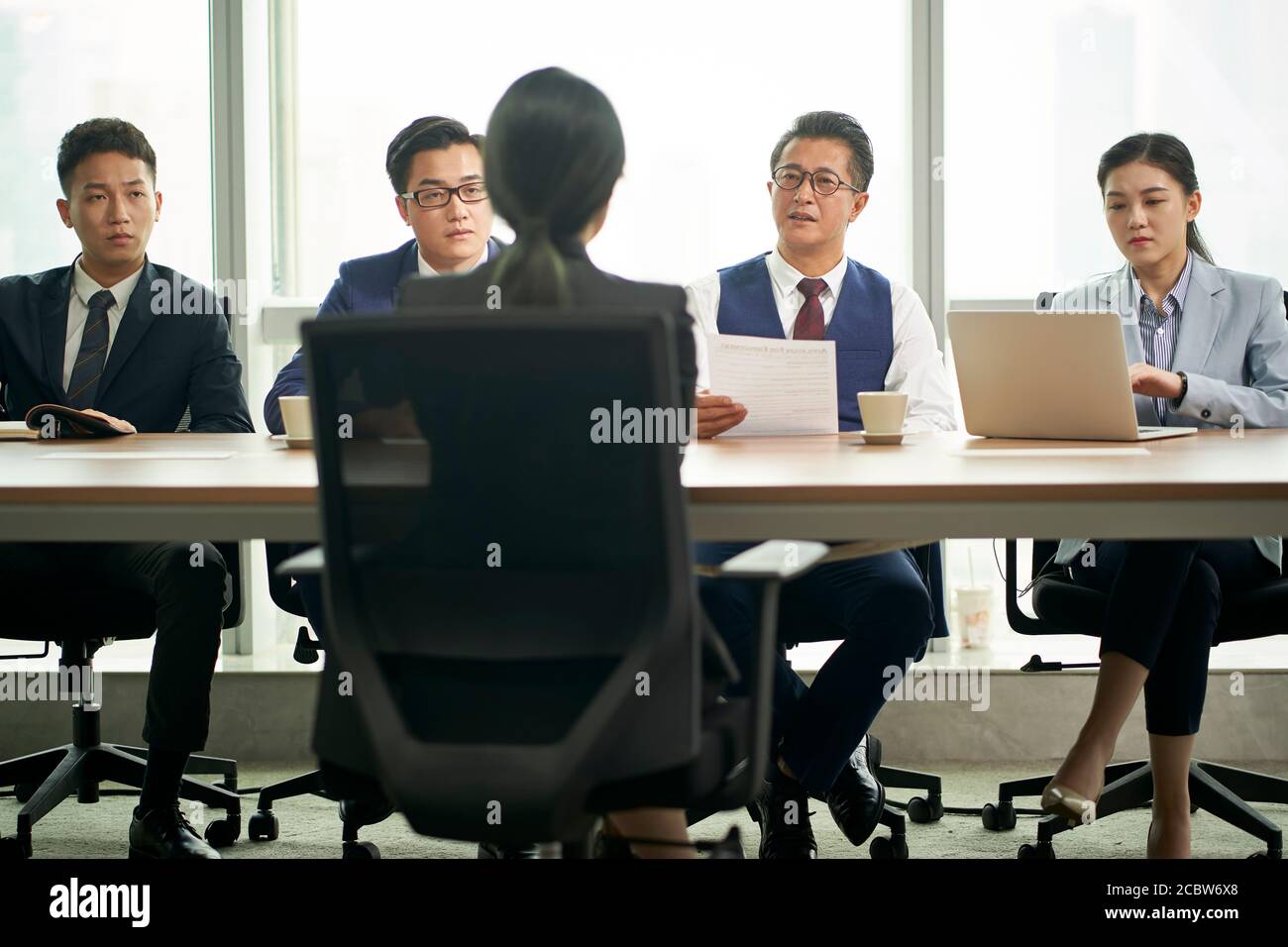 young asian business woman being interviewed by a group of corporate hr executives Stock Photo