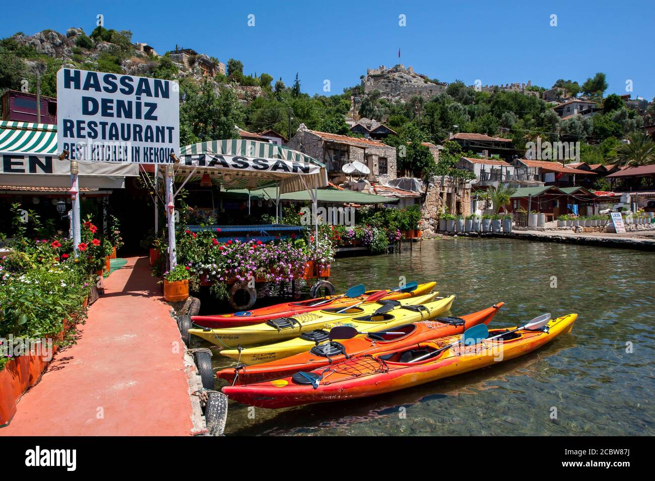 The village of Kalekoy on the Turkish Mediterranean. It is famous for the ruins of Simena and the Crusader fortress perched on the hilltop above Stock Photo