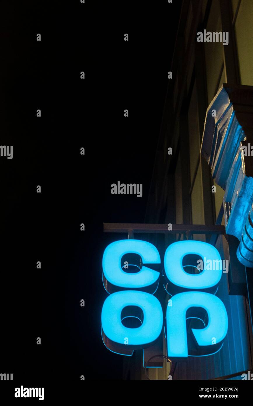 A neon blue Co-op supermarket sign at night Stock Photo