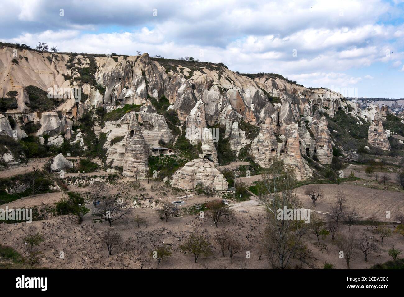 A hill side covered with volcanic rock formations known as fairy chimneys near the Open Air Museum at Goreme in the Cappadocia region of Turkey. Stock Photo