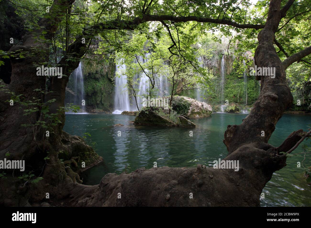 The magnificent Selale Waterfall surrounded by a forest of trees near Antalya in Turkey. The waterfall was formed by a karstic depression. Stock Photo