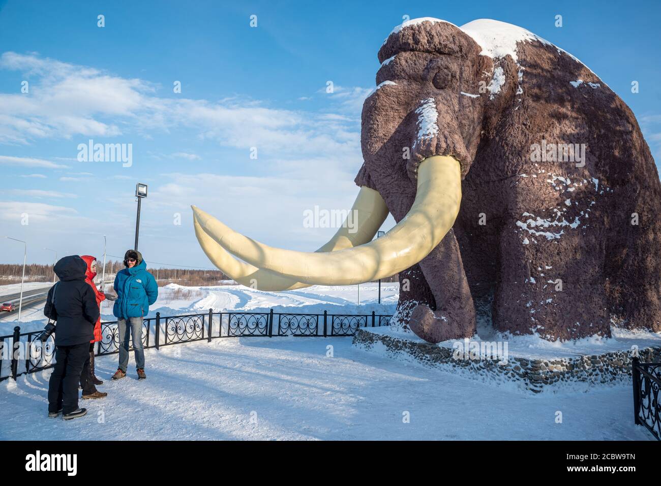 Tourists in front of the monument to a mammoth at the entrance of Salekhard, Yamalo-Nenets Autonomous Okrug, Russia Stock Photo