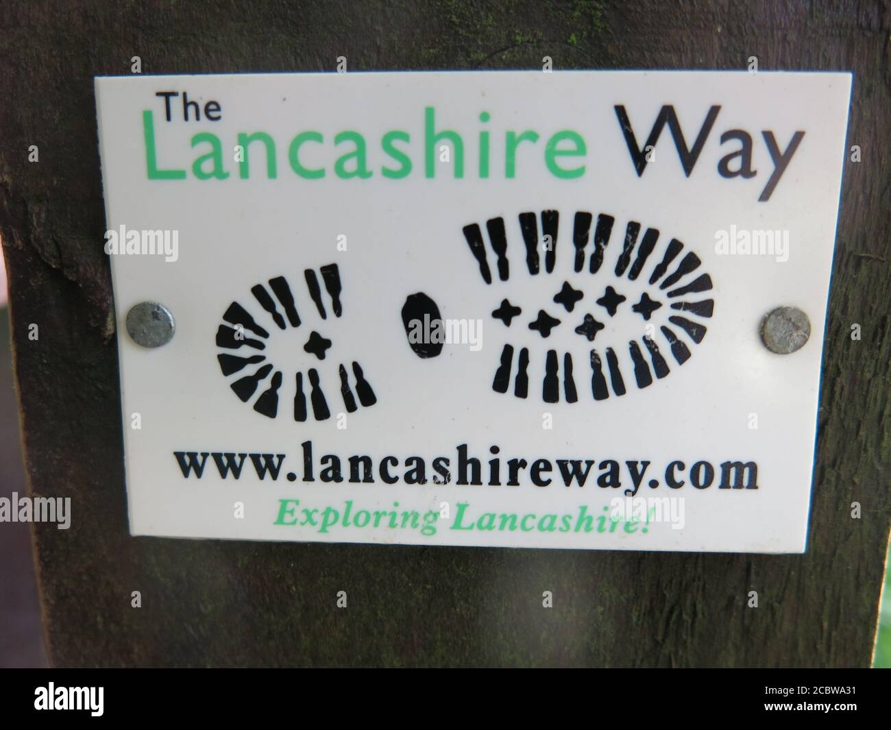 A signpost and logo marking the route of The Lancashire Way, a long distance footpath for walkers and hikers to explore the scenery of the county. Stock Photo