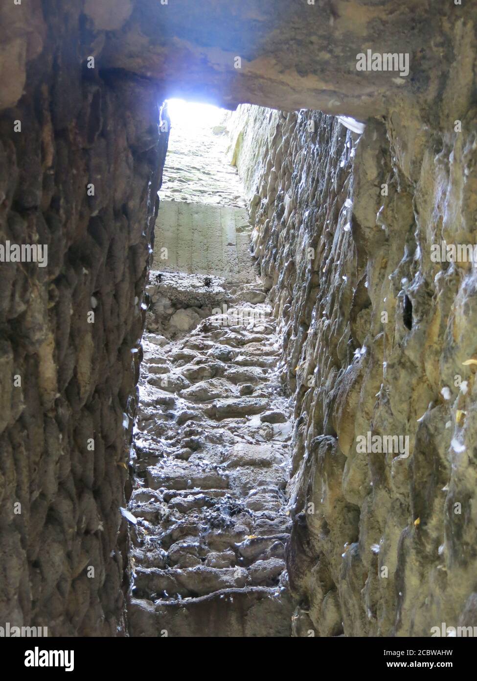 Looking up through the remains of an old stone chimney in the ruins of Whalley Abbey, where the grounds are open to the public. Stock Photo
