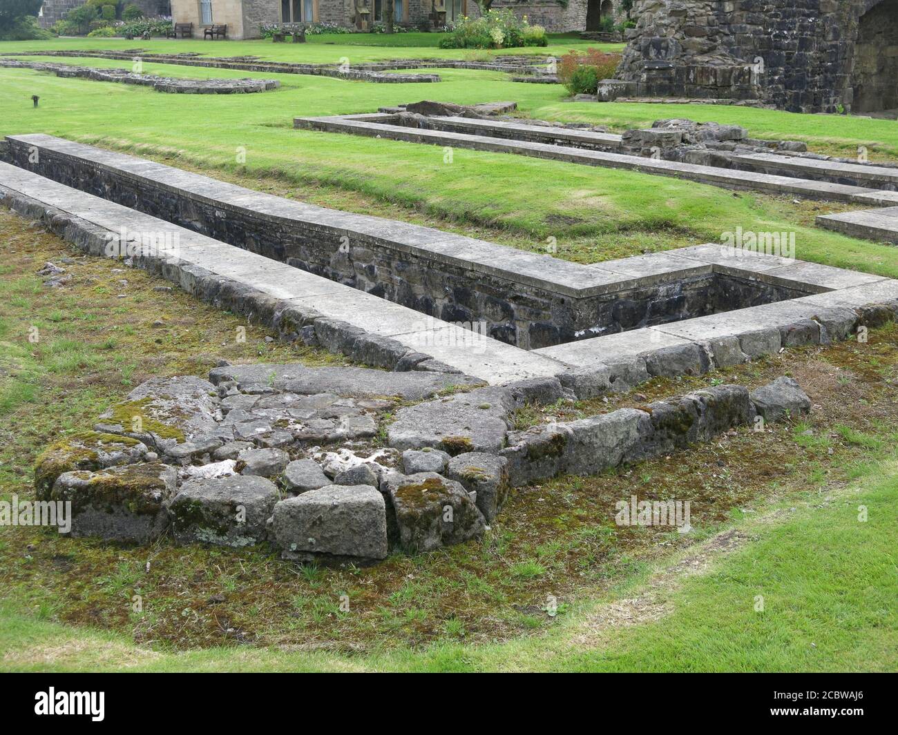 The foundations of the only surviving choir pits in Britain, stone-lined trenches in the ruins of Whalley Abbey, a 14th century Cistercian Monastery. Stock Photo