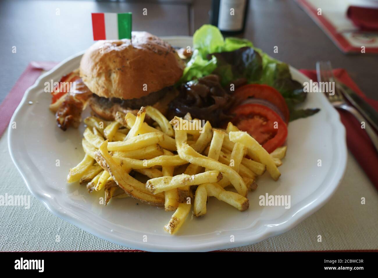 A 300 gr chianina Hamburger with tomatoes and french fries - La Fratta farm - Bettolle - Sinalunga, Siena, Tuscany, Italy Stock Photo