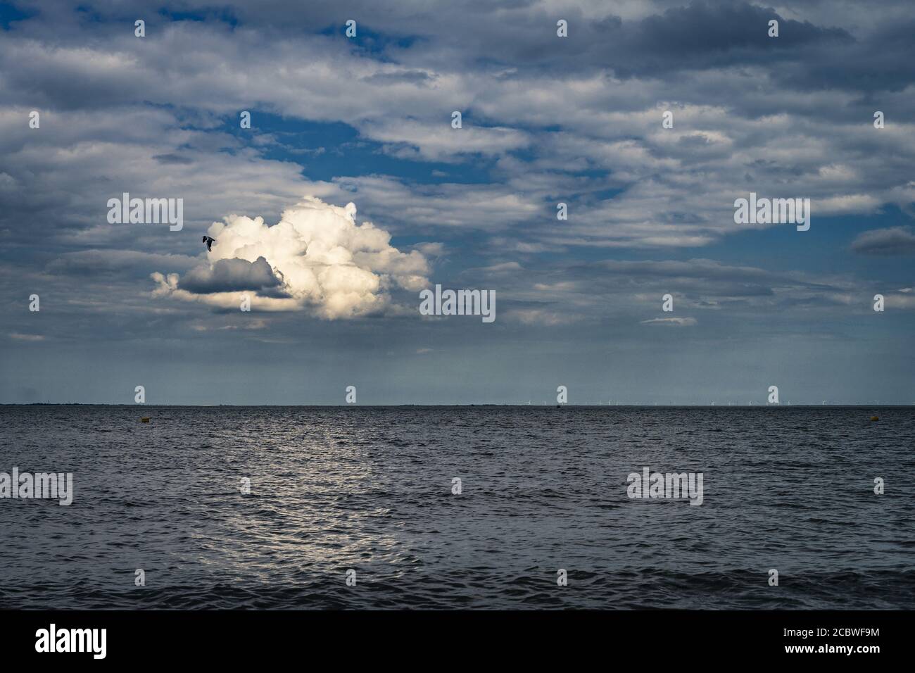 Lonely cloud above sea Stock Photo