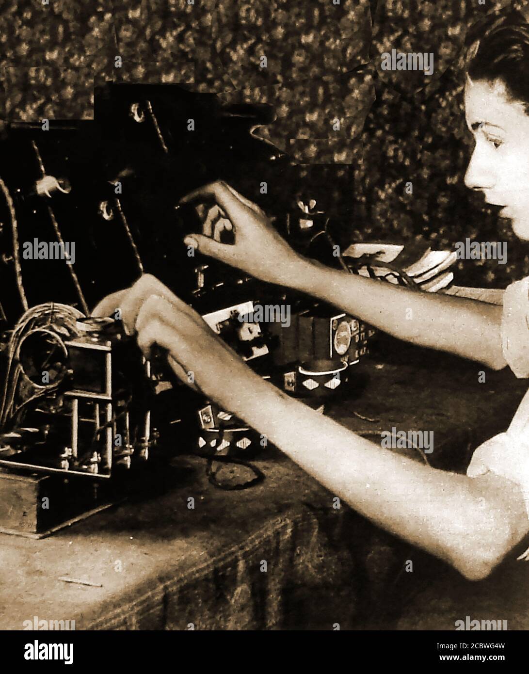 1922 A young woman operating one of the newly invented radios of the time.Analog audio (AM) was the earliest form of radio broadcast. that began around 1920. FM broadcasting was introduced in the late 1930s Stock Photo