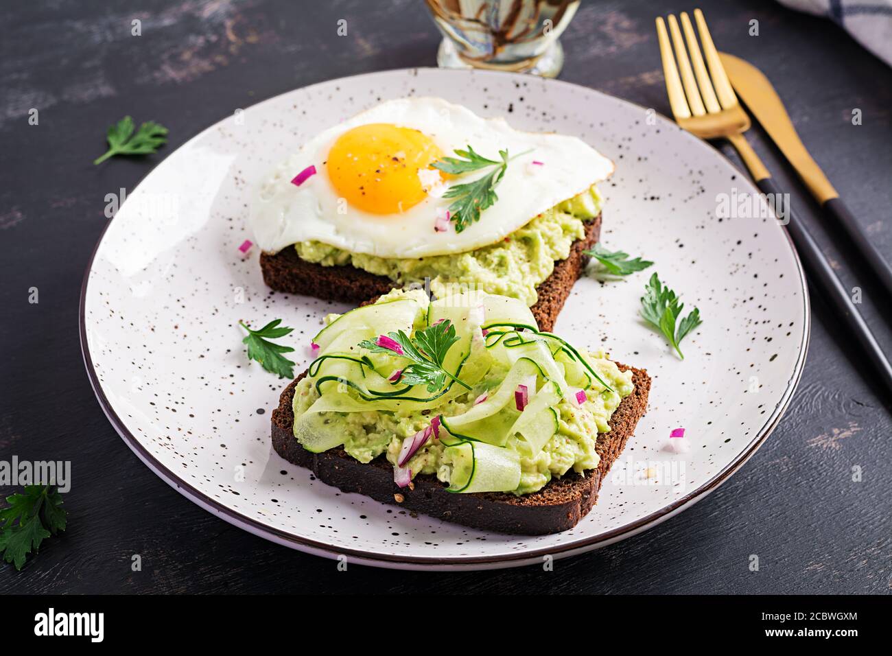 Healthy Breakfast Sandwich With Avocado Guacamole Cucumber And Fried Egg For Healthy Breakfast Or Snack Stock Photo Alamy