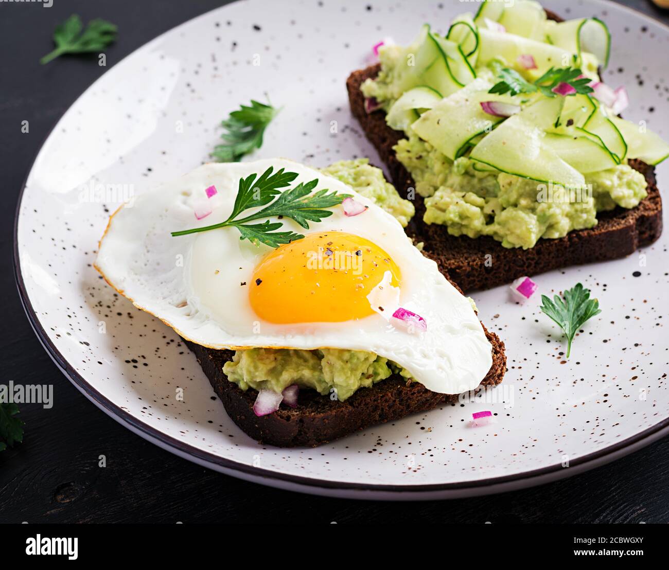Healthy Breakfast Sandwich With Avocado Guacamole Cucumber And Fried Egg For Healthy Breakfast Or Snack Stock Photo Alamy