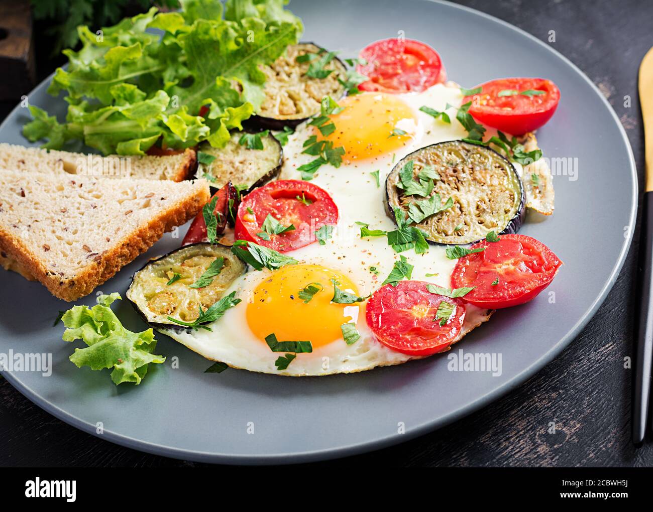 English breakfast fried eggs, tomatoes and eggplant. American food