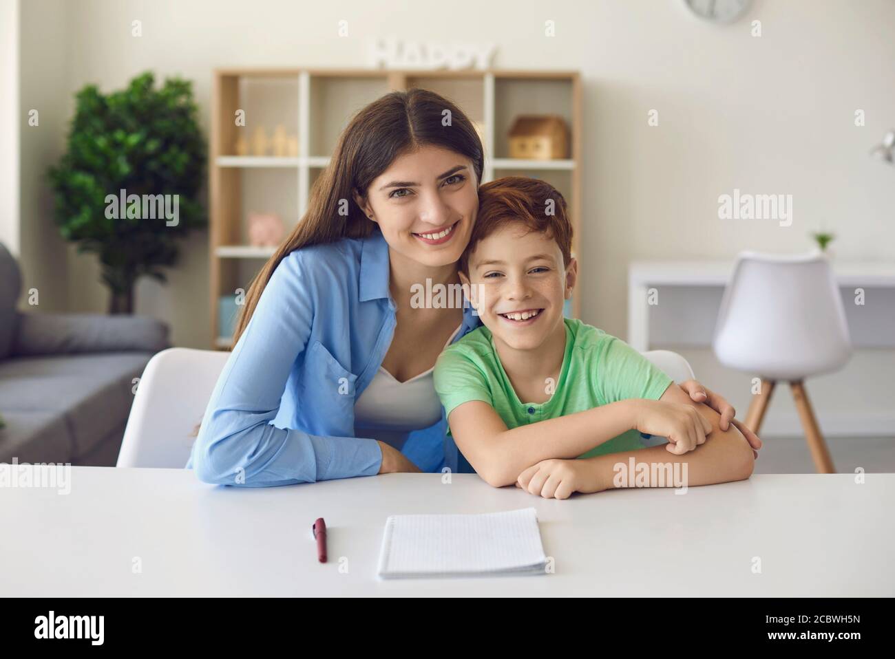 Online communication or distance schooling. Mother and son talking to family, friends or teacher on web Stock Photo