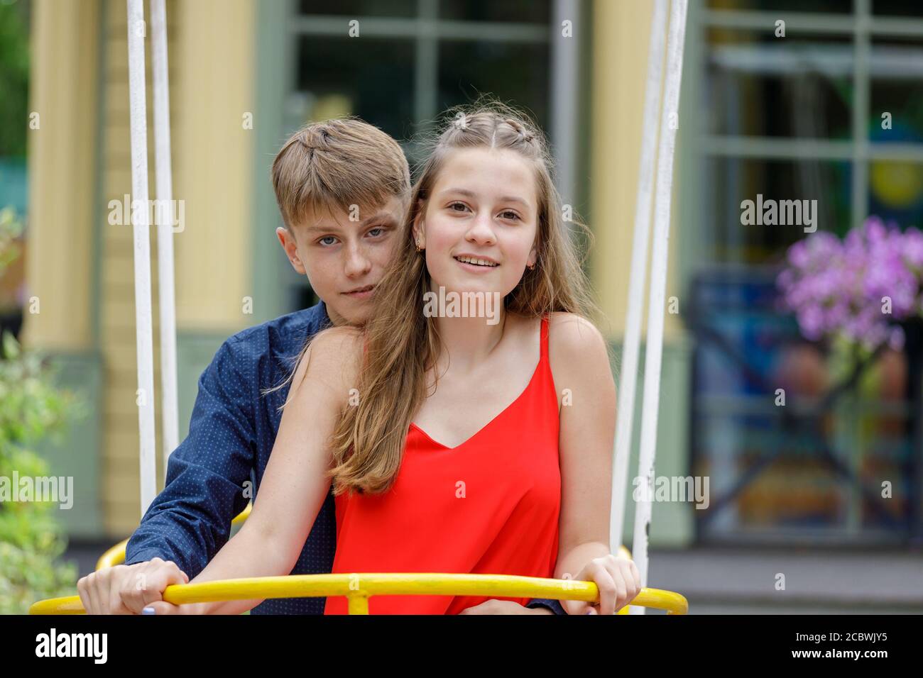 young couple having fun on a swing in the park Stock Photo