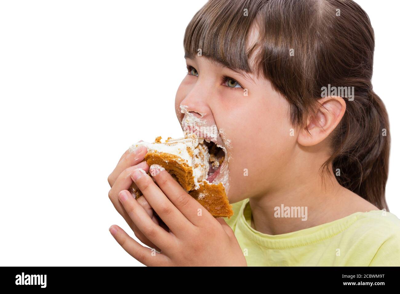 Girl eating cake. Isolated on white background. Stock Photo