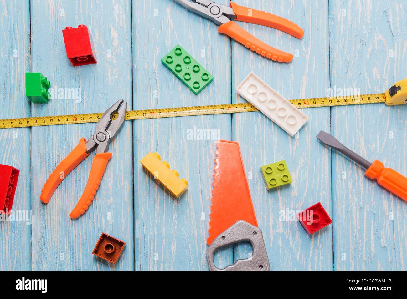 Plastic hammer, saw, pliers, toys Stock Photo - Alamy