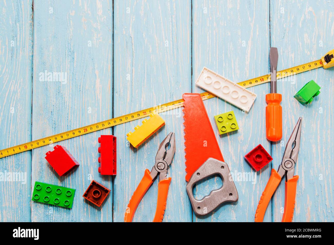 Plastic hammer, saw, pliers, toys Stock Photo - Alamy