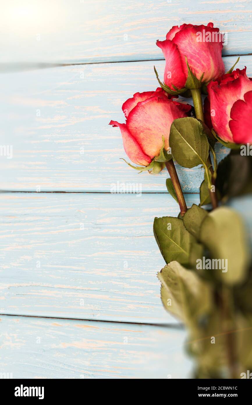 Romantic background with red roses on wood table Stock Photo - Alamy