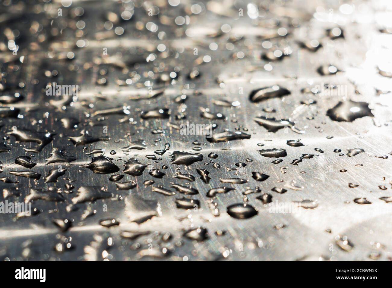 water drops on a shiny metal surface. background. Stock Photo