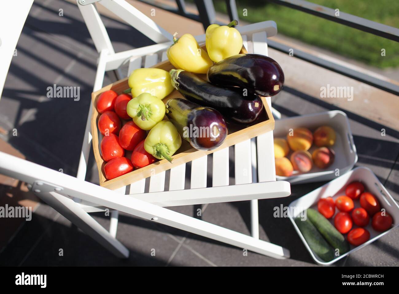 Decontaminating vegetables on a balcony under sun light during COVID pandemic Stock Photo