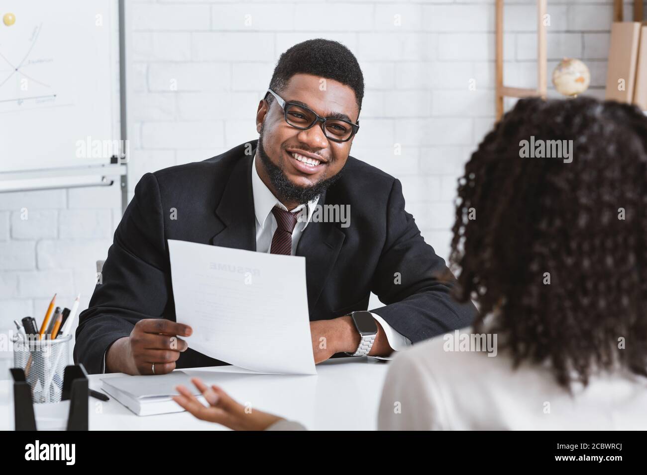 Happy personnel manager and young job applicant on work interview at company office Stock Photo